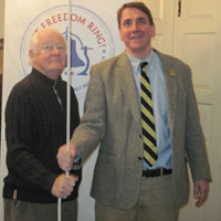 Ron Monark and Todd Mooradian ring the bell at First Baptist Church.